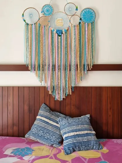 Our cluster dreamcatchers add a perfect touch of boho aesthetic to any bedroom. This piece, with its calming blue and neutral tones, looks beautiful placed above the headboard, creating a serene focal point.