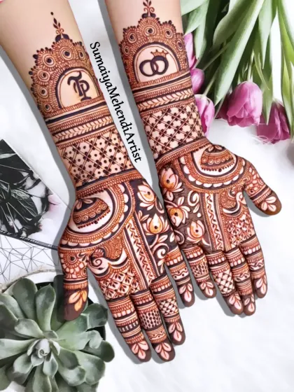 Perfect for an engagement or for the bride who wants a more minimal look. This semi bridal design features the couple's initials and wedding rings, blending personal symbols with elegant patterns that extend to the mid-forearm.