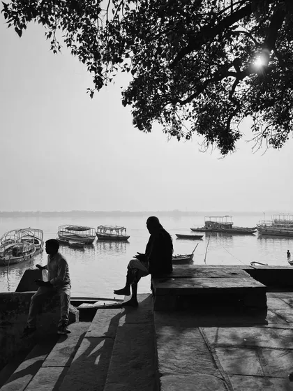 a quiet morning moment on the ghats. this black and white composition focuses on silhouette and form, stripping away distraction to focus on the essential subjects.