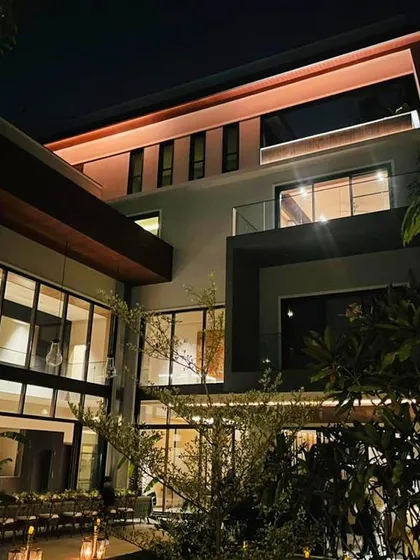 The residence at night, with interior and exterior lighting creating a dramatic effect. Our lighting scheme was designed to accentuate architectural features and create a sophisticated ambiance throughout the property.