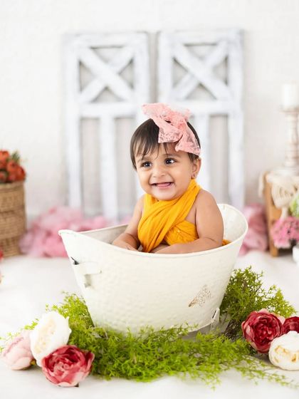 This little princess is enjoying her flower bath. The combination of warm water and colorful flowers makes for happy smiles.