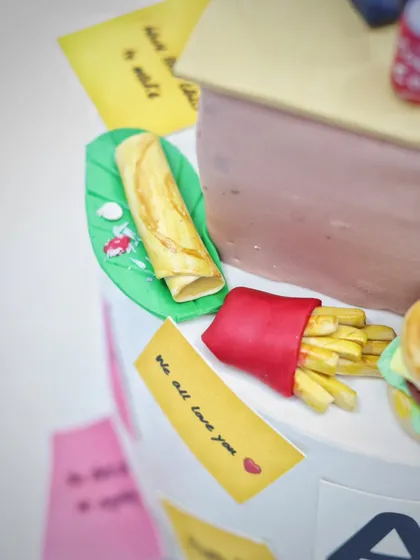 A close-up of the tiny, edible spring roll and french fries.