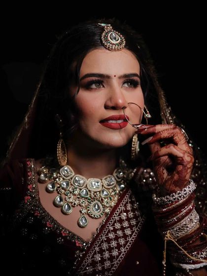 A dramatic shot of this beautiful bride. The focus is on her expressive eyes and bold red lips.