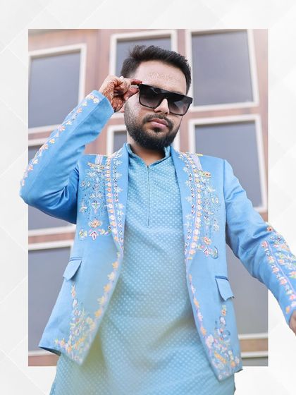 Confidence and style personified. This groom wears our sky-blue embroidered jacket and kurta set, a perfect choice for pre-wedding festivities that call for a celebratory and modern ethnic look.