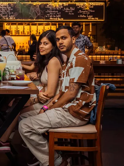 A couple enjoys a date night at Roxie, seated at our bar with its warm, inviting glow.