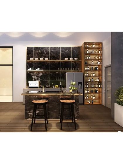 This terrace includes a stylish outdoor bar and kitchen area, complete with a marble island, bar stools, and integrated appliances. It’s perfect for entertaining guests.