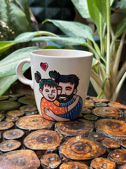 A sweet, illustrated hug between a father and his daughter on a custom Father's Day mug.