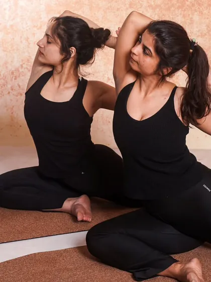 Stronger together. Here, we are practicing Eka Pada Rajakapotasana (One-Legged King Pigeon Pose), supporting each other's practice and building a community of growth.
