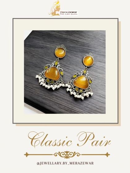 This pair of classic dangle earrings features a warm yellow stone. It's a cheerful and bright option, perfect for festive occasions or summer events.