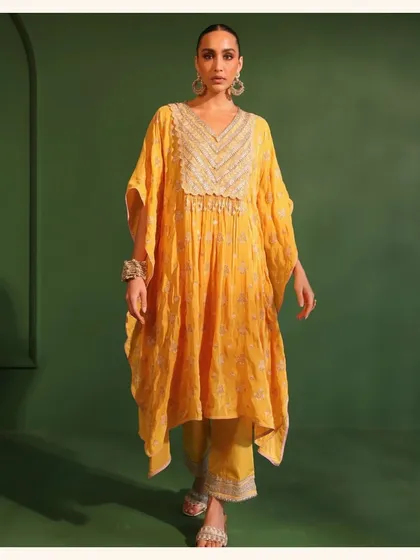 This yellow kaftan set is the epitome of comfy chic. It's perfect for a relaxed festive gathering where you want to look stylish without compromising on comfort.