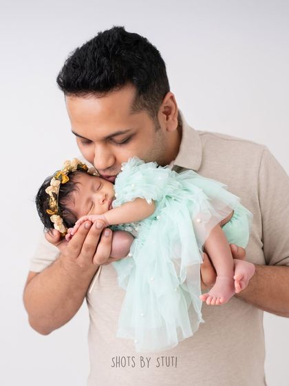 A father's gentle kiss for his newborn daughter. These are the quiet, tender moments that truly define fatherhood.