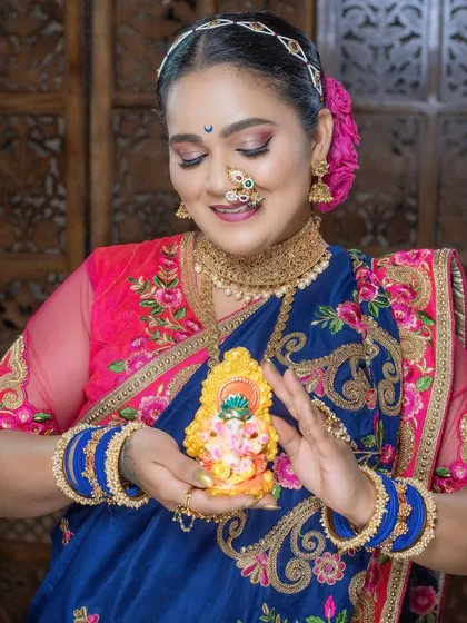 A serene moment captured, showing the detailed makeup and the beautiful idol.