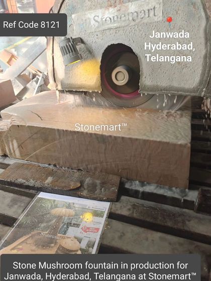 A large saw cuts a block of sandstone, the first step in creating a mushroom fountain.