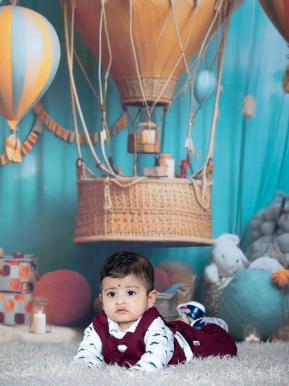 A curious baby exploring the hot air balloon set.
