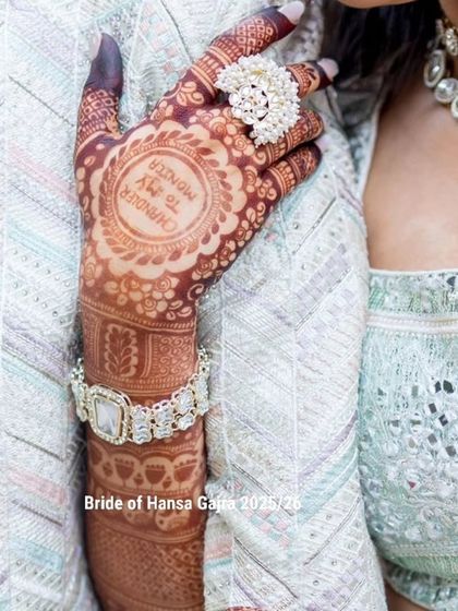 A personalized back-of-hand design with a "Friends" TV show reference, "Chandler to my Monica," enclosed in a beautiful mandala. It's a perfect example of telling a personal story.