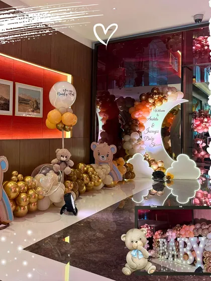 A collage showing various elements of a gold and brown teddy bear baby shower, including the crescent moon backdrop, balloon decor, and custom 'BABY' blocks.