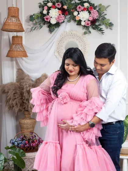 A sweet moment of connection between the couple. His hand gently on her bump shows his love and support.