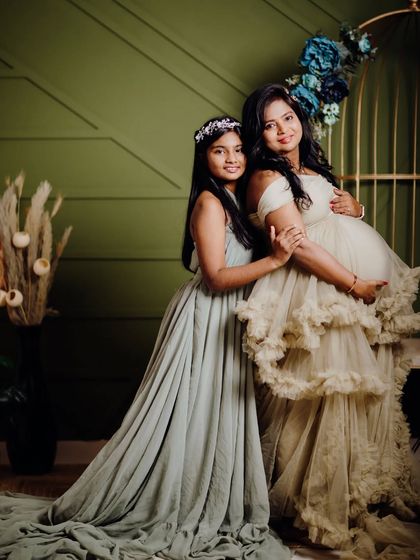 A beautiful portrait of a mother and her older daughter during a maternity session. I provide gowns for both mom and the kids to make sure everyone looks coordinated and beautiful.