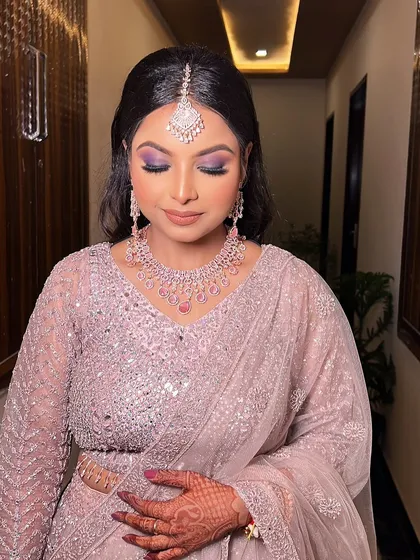 A close-up of the dramatic purple eye makeup. This is a great way to add a pop of color and create a memorable look for your sangeet or engagement.