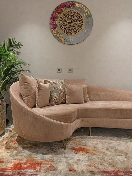 The custom-designed curved chaise lounge, providing a luxurious spot for relaxation in the master bedroom.