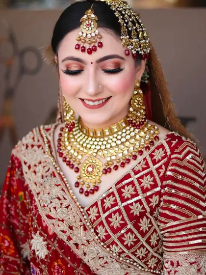 Eyes closed, this shot highlights the beautiful eye makeup and the intricate details of the passa and maang tikka.