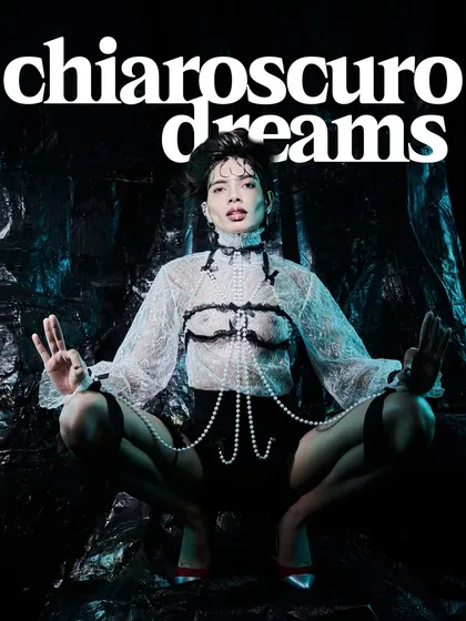 This shot, from a series called 'Chiaroscuro Dreams', is where fashion meets art. I used high-contrast lighting to emphasize the texture of the lace and the sheen of the pearls, creating a powerful, edgy image that was featured in a magazine editorial.