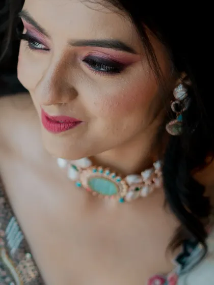 A close-up shot focusing on the bride's stunning makeup and jewelry.