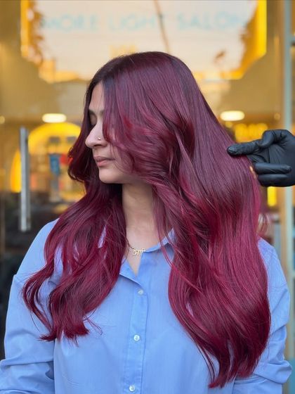 Shades that speak louder than words. This magenta-red look is vibrant and playful, perfect for anyone looking to express their personality through their hair.