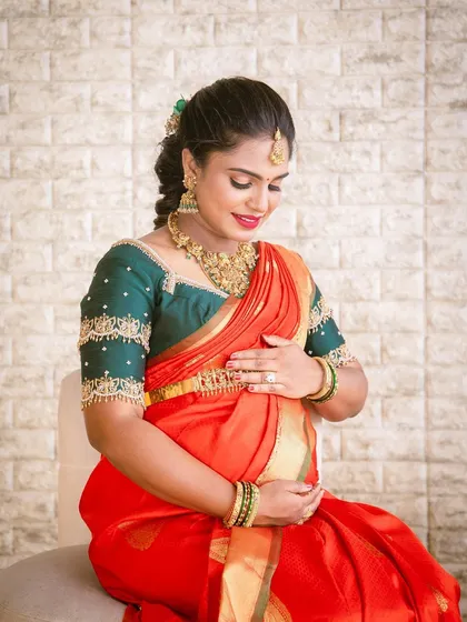 Archana looking serene and beautiful during her baby shower. The soft makeup look enhances her natural features and the happiness of the moment.