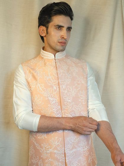 Our custom-made garments are designed to be a perfect fit, reflecting your unique style and personality, as seen in this elegant peach jacket.