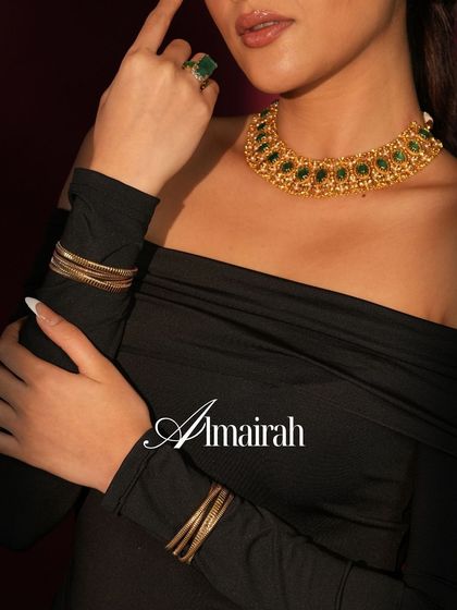 A powerful look featuring our carved gold and emerald choker, paired with a stack of our everyday gold bangles.