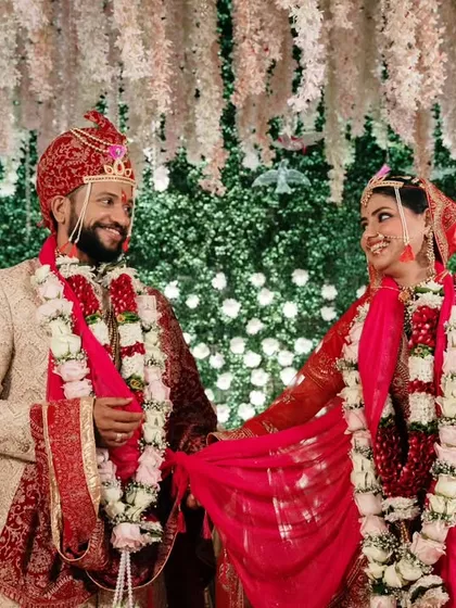 A moment of shared laughter during the Varmala ceremony. This candid shot captures the fun and joy of Indian wedding rituals.
