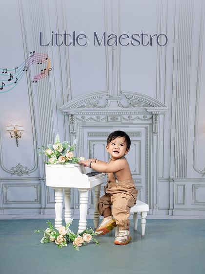 The keys to cuteness are unlocked by our little maestro. This simple, elegant setup with a mini piano creates a timeless and adorable portrait.