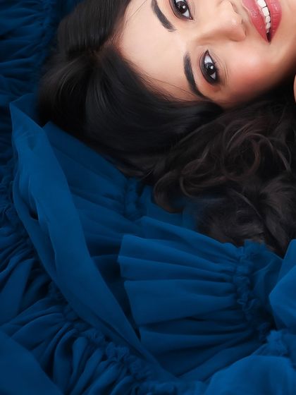 A collection of artistic shots featuring a gorgeous royal blue gown, from full-length portraits to creative close-ups on the fabric and bump.