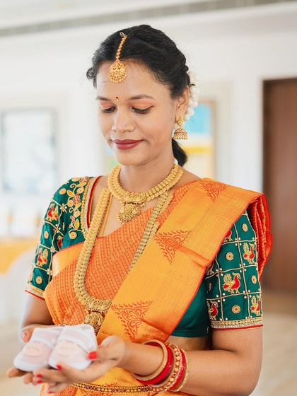 Our client Saranya celebrating her baby shower. She looks serene and beautiful in a classic gold Kasu haram (coin necklace) and matching choker.