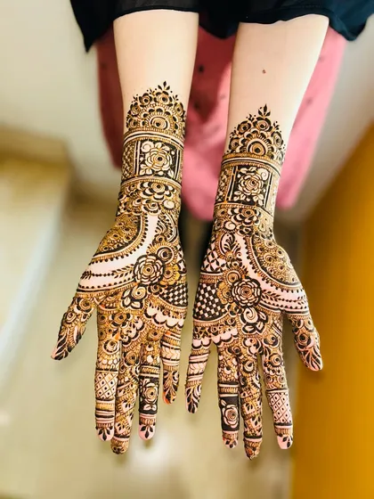 A beautiful non-bridal design with a mix of floral and geometric patterns. The cuff at the wrist is particularly detailed.