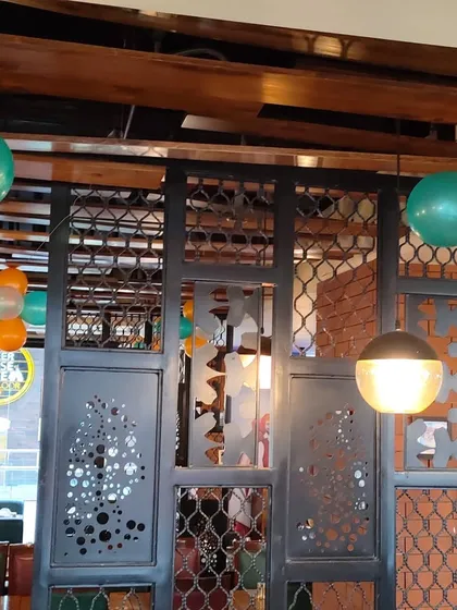 This photo gives a closer view of our balloon decorations for a special event at a cafe. The simple yet effective tri-color balloon bunches add a celebratory touch to the venue's modern interior without overwhelming the space. We can work with any venue to match the theme and decor.