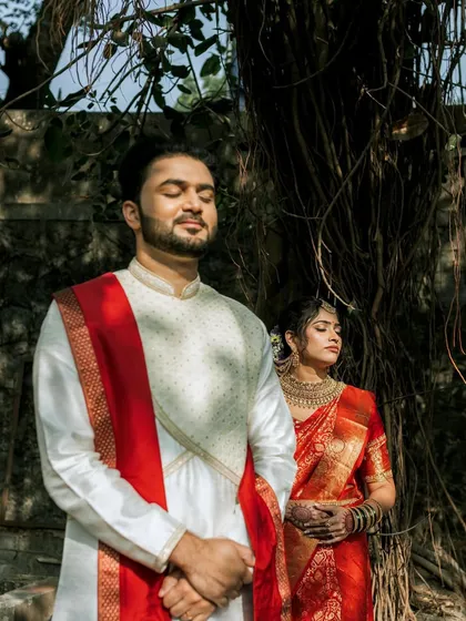 A beautiful couple portrait. The bride's classic red look stands out, with her makeup enhancing her features and complementing her partner's attire.
