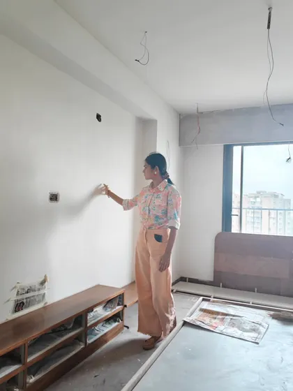 Checking the texture and condition of a wall before starting a project. Proper surface preparation is essential for a long-lasting mural.