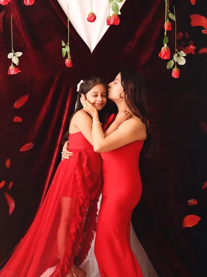 A warm embrace and a gentle kiss on the forehead. This photo beautifully captures the protective and nurturing love a mother has for her child.