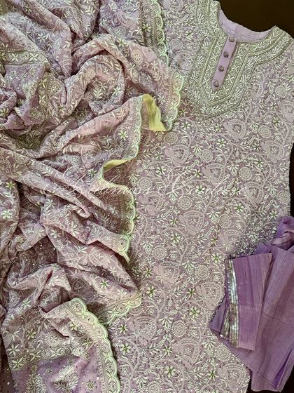 A full view of the lilac Anarkali, showcasing the scalloped dupatta finished with pure tissue. The sheer volume of the fabric and embroidery creates a breathtaking effect.