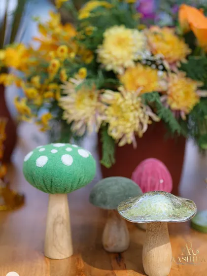 A macro shot of the adorable handcrafted mushroom decor pieces, made from felt, wood, and metal.