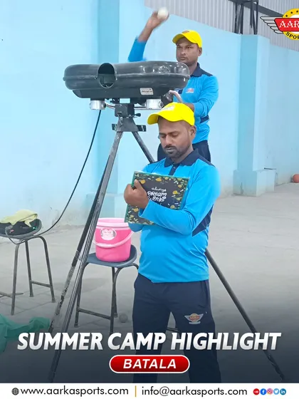 A coach sets up the bowling machine for a session at the Batala summer camp. We use modern technology to enhance our training.