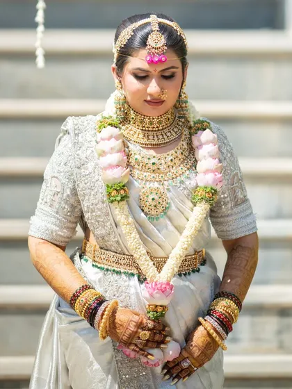 The final, mature stain after 48 hours. The bride's hands are adorned with a deep, reddish-brown color that looks absolutely stunning with her white and gold wedding saree.