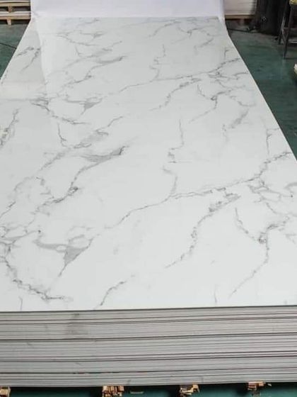 Another stack of our white PVC marble sheets, ready for installation. This is a popular choice for a clean, bright, and modern look.
