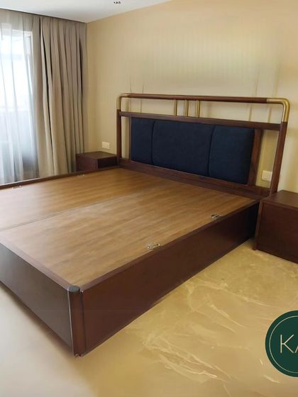 Another view of the dark wood and brass-accented bed, showing how it pairs with matching wooden nightstands. This cohesive set creates a warm, sophisticated, and unified bedroom aesthetic.