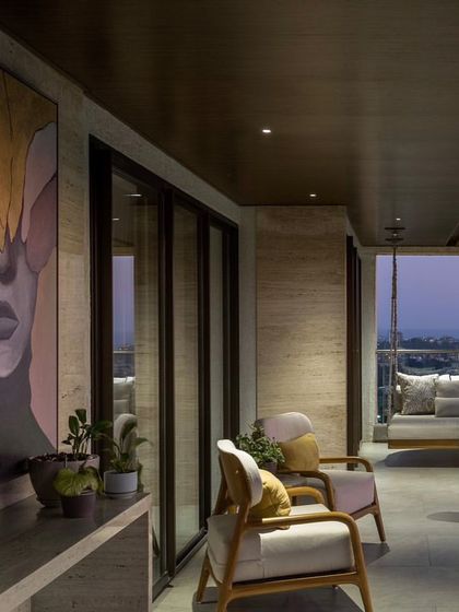 A very large, stunning portrait installed on a balcony in Mumbai. The abstract, leaf-like shapes covering the eyes give it a surreal and mysterious quality.