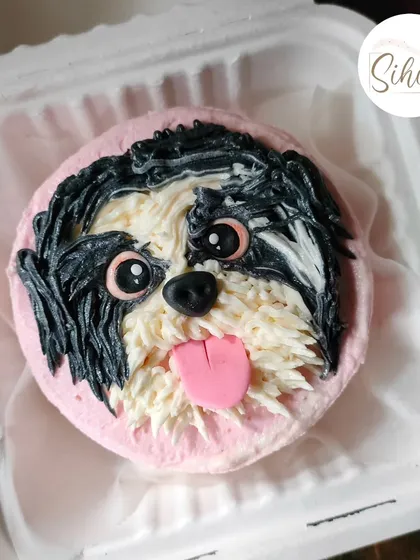I love creating edible portraits of your furry friends. This Shih Tzu bento cake uses intricate buttercream piping techniques to replicate the dog's fur texture, creating a realistic and adorable tribute.