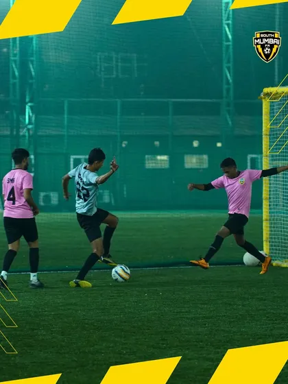 Game on. A player skillfully maneuvers the ball while a teammate provides support. This is strategy and teamwork in action.