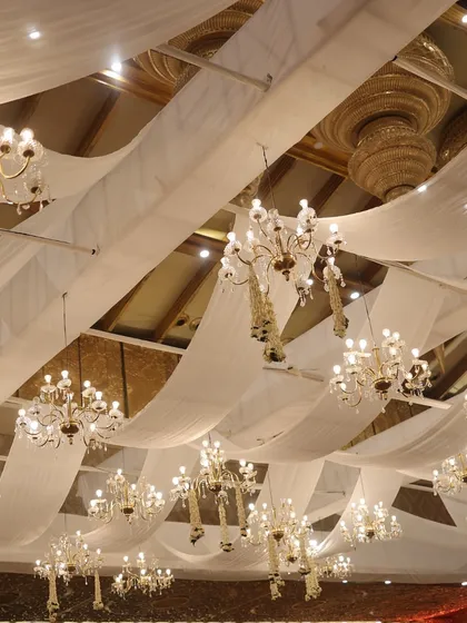 A ceiling of flowing white drapes and dozens of crystal chandeliers. This image, titled "Golden Threaded Love," captures the dreamy, ethereal atmosphere we can create.
